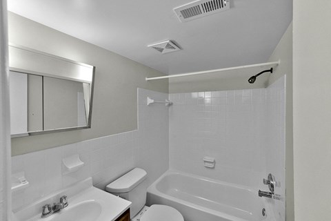 a white bathroom with two sinks and a shower